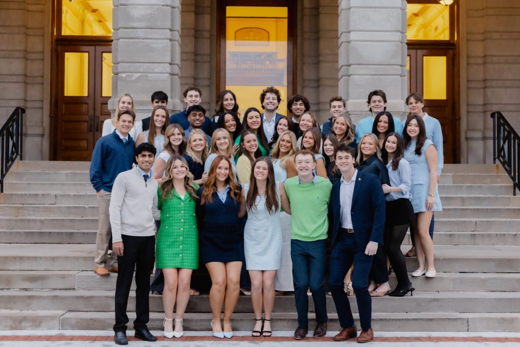 Greek week steering committee standing and smiling as a group